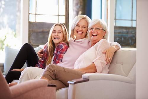 Mother, daughter, and granddaughter smiling